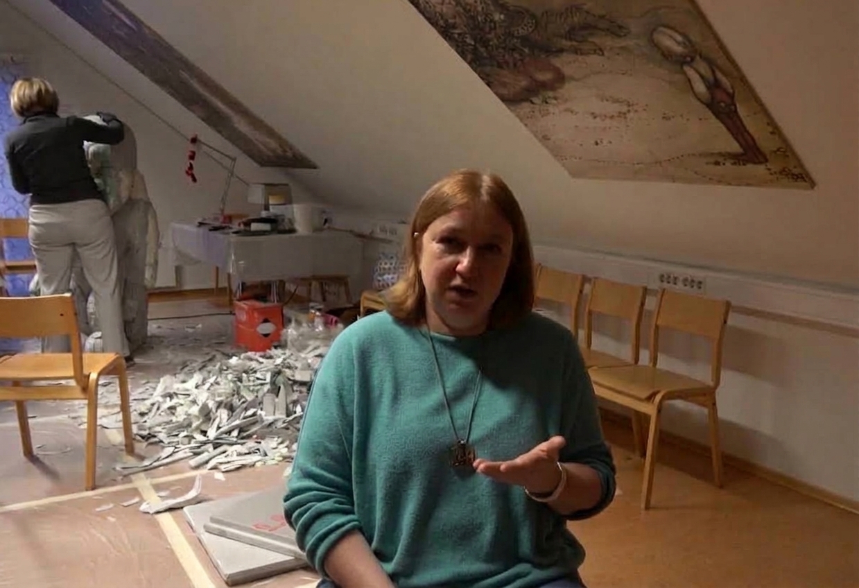 a woman seating against a background of creation a new troll figure